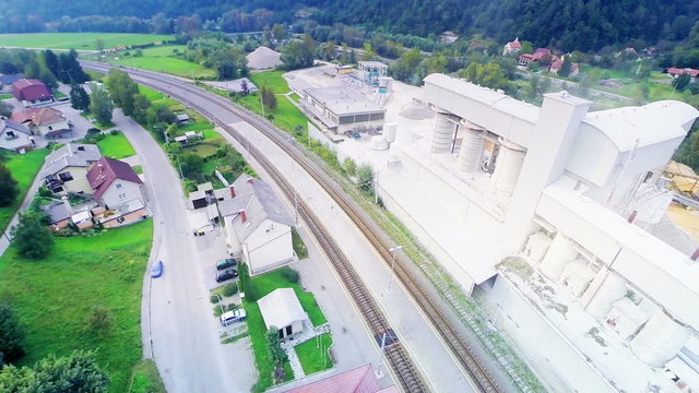 Aerial flight over railway with factory