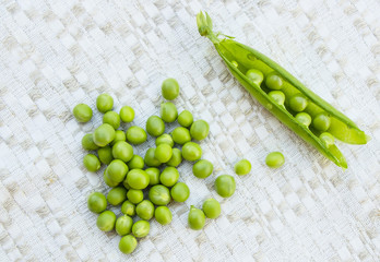Green peas on the vintage linen background