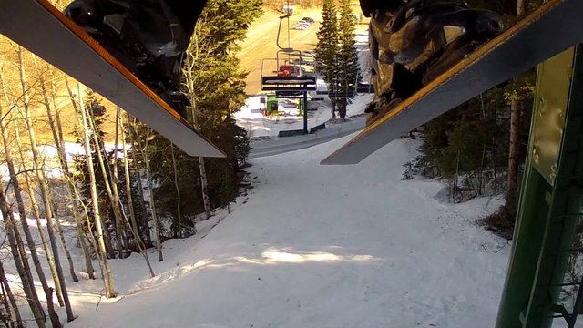 skis and boots riding up a lift