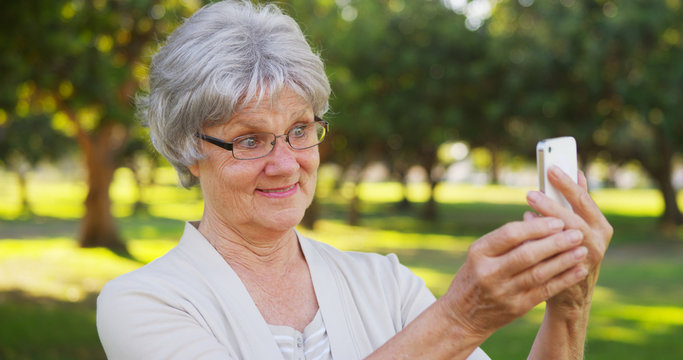 Hip grandma taking selfies at the park