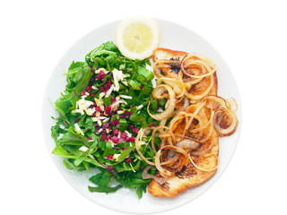 fried turkey fillet with onions, fresh mixed greens and lemon