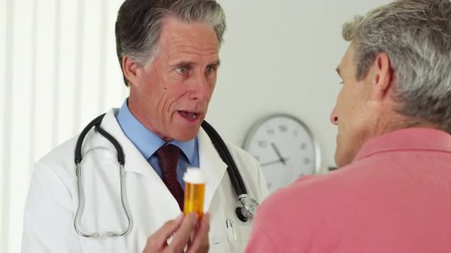Doctor talking to elderly patient about prescription
