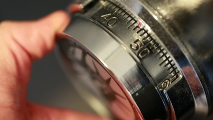 hand opening a combination lock on safe