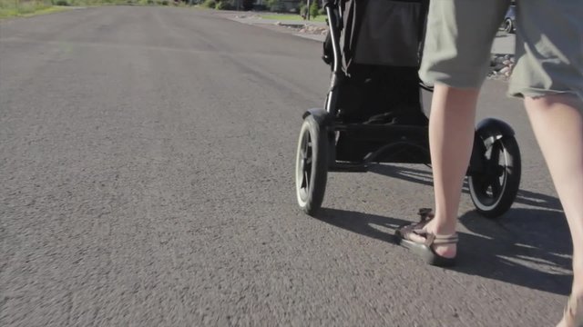 mother pushing baby in a stroller
