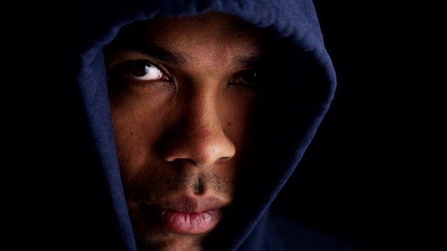 Black man wearing blue sweater