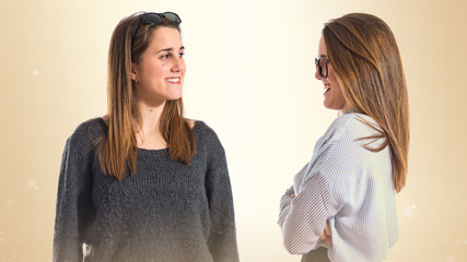 Twin sisters looking each other