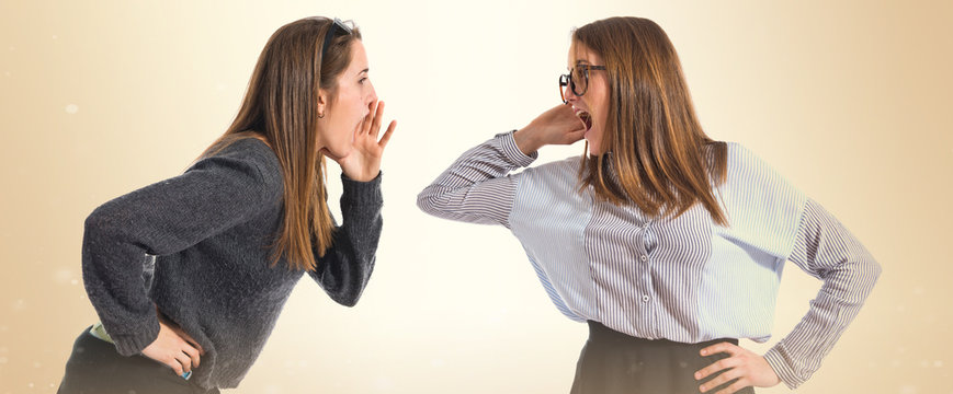 One girl shouting and other listening