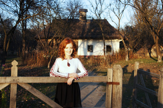Redhead Ukrainian near a country house