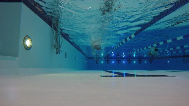 Underwater shot of man swimming freestyle in a pool
