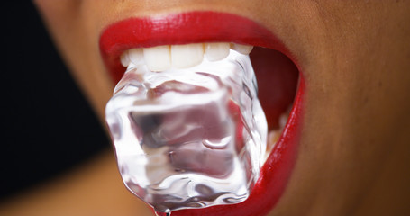 Closeup of woman biting ice