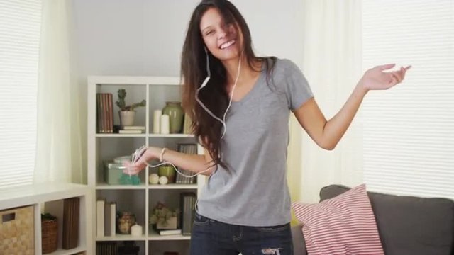 Attractive woman dancing with her music player