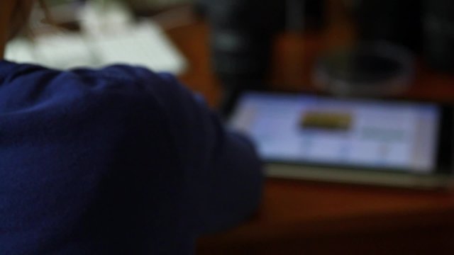a woman at home office on computer and ipad
