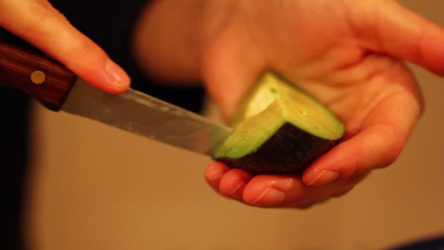 slicing avacodo on mexican salad