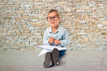 Fototapeta premium Little girl with glasses studing