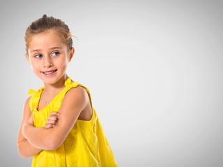 Blonde little girl walking with her arms crossed