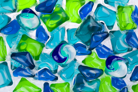 Background of all-in-one capsules with laundry detergent and dishwasher soap