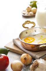 Turkish breakfast with egg in copper pan