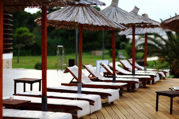 Beach umbrellas at the hotel lounge chairs
