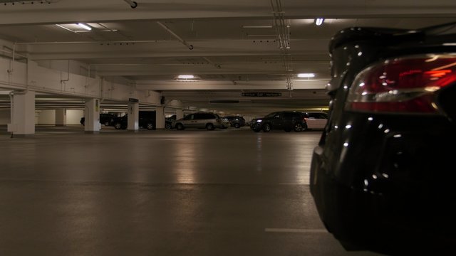 Cars driving in underground parking garage