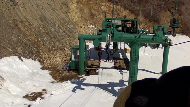skier gets on chair lift