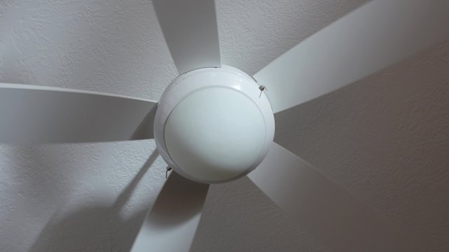 A ceiling fan turned on
