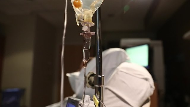 woman in labor at hospital on bed with iv drip