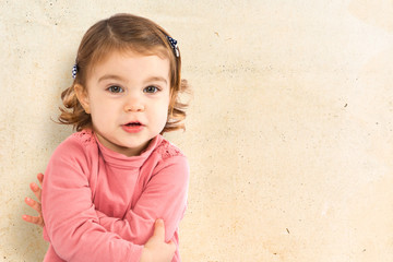 Little girl sitting over isolated white background