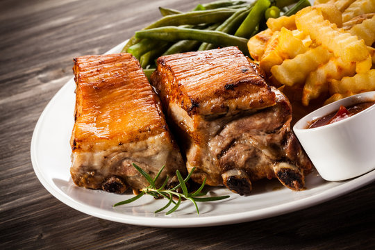 Grilled ribs, boiled potatoes and vegetables 