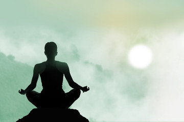 women meditating colorful on high mountain in sunset background