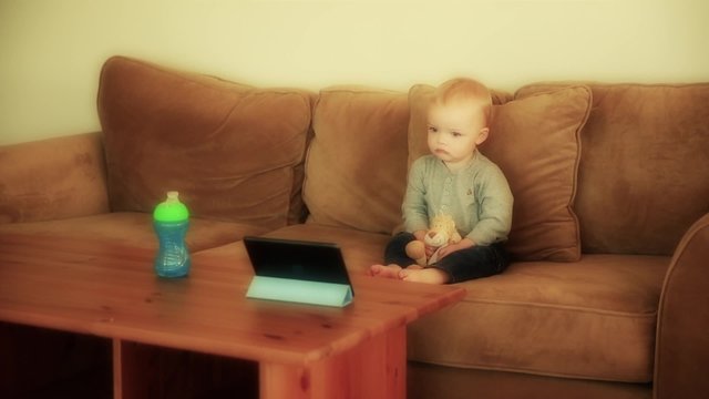 baby boy watching show on a tablet