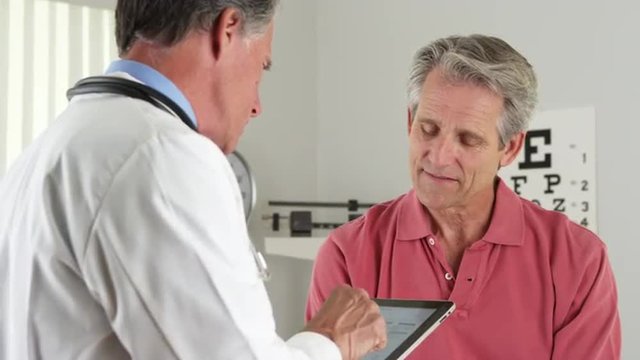 Senior doctor asking elderly patient questions