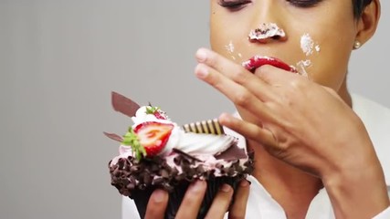 Black woman making a mess eating a huge fancy dessert - Powered by Adobe
