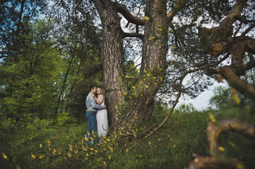 Newly-married couple in the wood about a tree 3181.