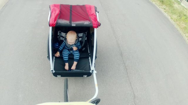 a baby boy in bike trailer