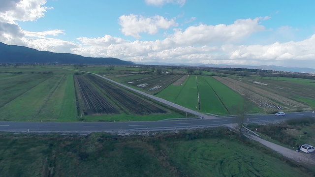 Aerial view of countryside with fields and road going through