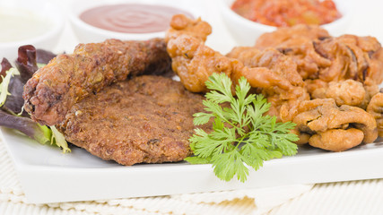 South Asian Starters - Selection of seekh and shami kebabs, mushroom and chicken pakoras and onion bhajjis. Served with salad, mint raita, lime pickled and chilli sauce.
