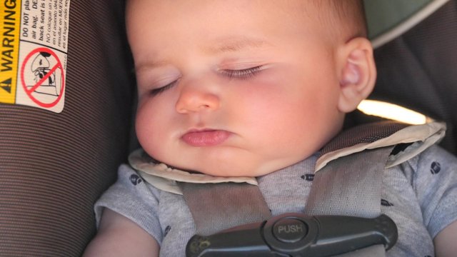 Newborn Baby Sleeping In His Carseat