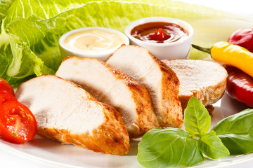 Roast chicken fillet and vegetables on white background 