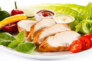 Roast chicken fillet and vegetables on white background 