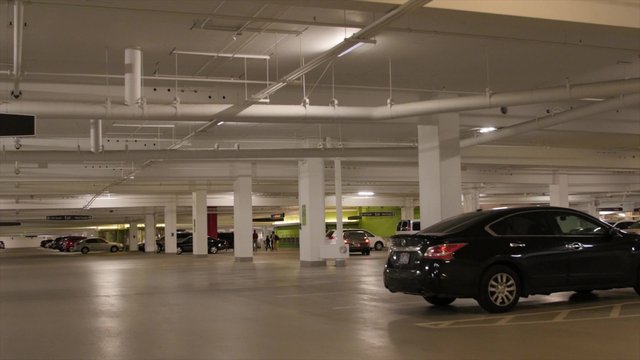 People and cars in parking garage