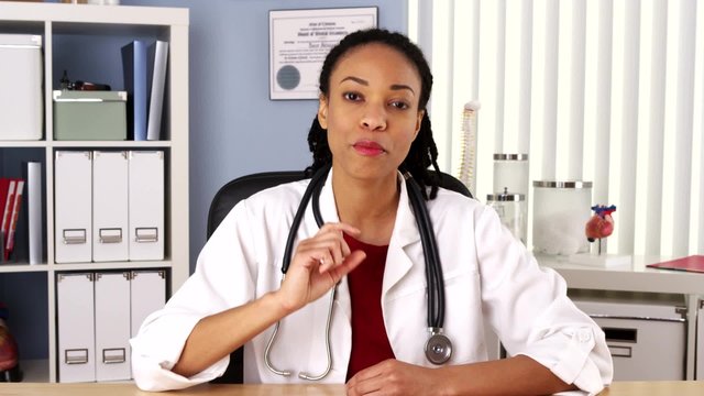 Female African American doctor talking to patient over video chat