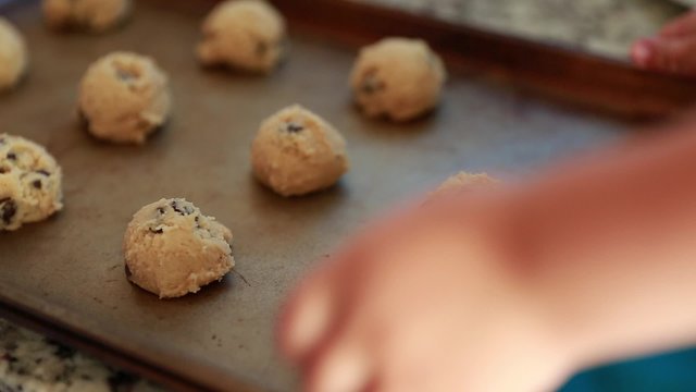 mother baking cookies with toddler