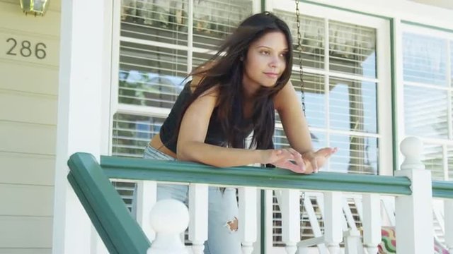 Mixed race woman leaning on rail