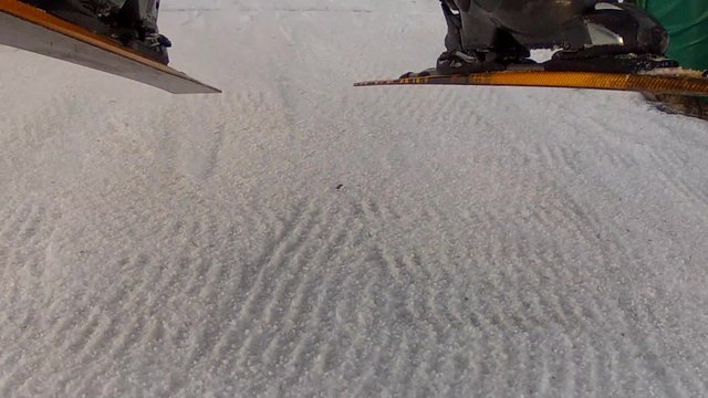 skis and boots riding up a chair lift