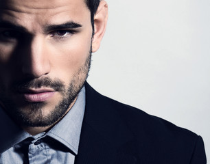 handsome young man in suit on grey background. Business man