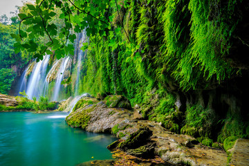 a beautiful waterfall in the forest on a river