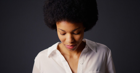 Portrait of black woman with afro and white blouse