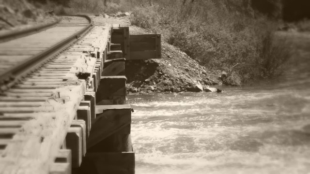 Old railroad bridge and river dolly shot