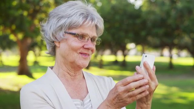 Hip grandma taking selfies at the park