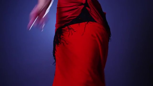 Female flamenco dancer twirling in red dress